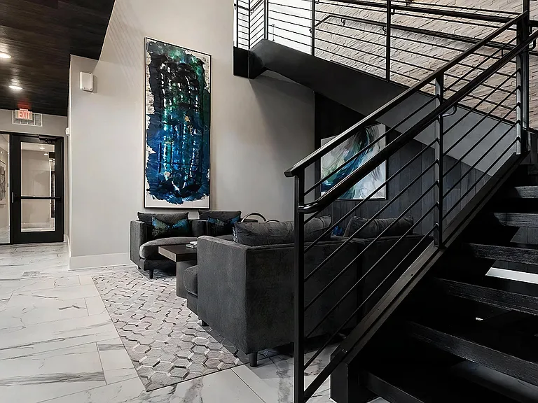 Contemporary Lobby with Black Staircase and Cozy Seating Area