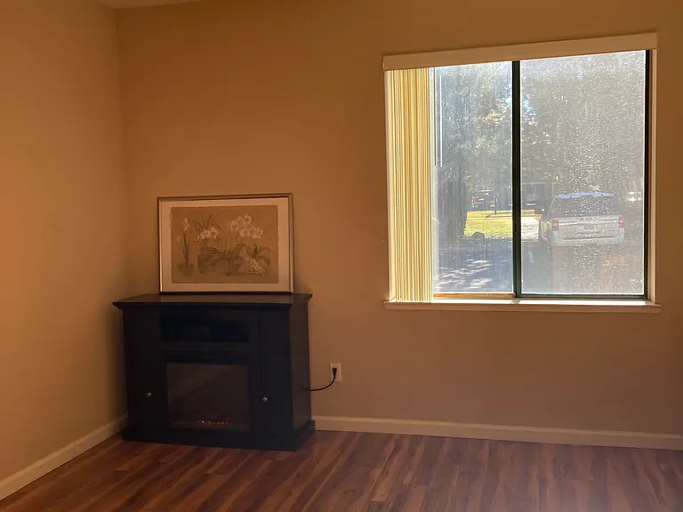 Primary Bedroom with Ceiling Fan and large window.