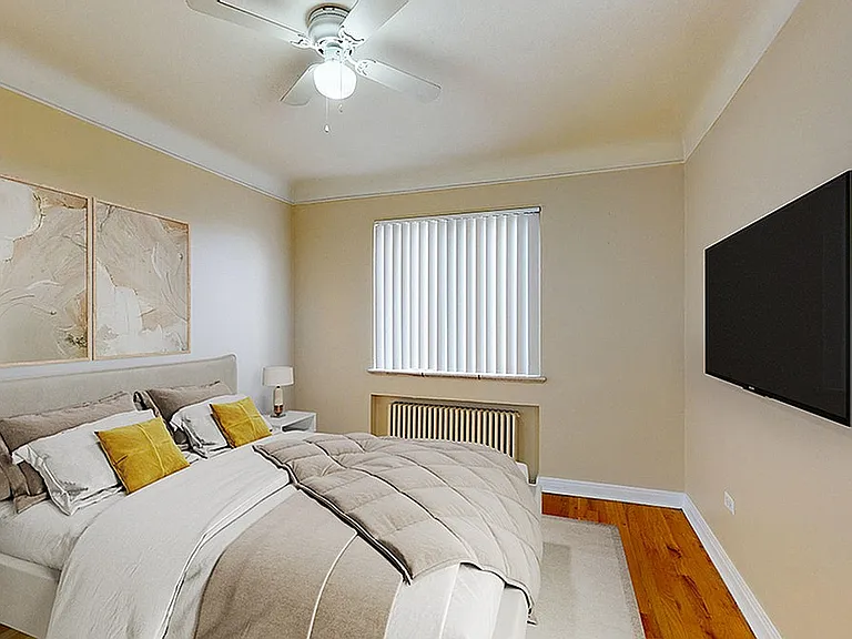 Elegant bedroom featuring a cozy bed with plush pillows, stylish wall art, a ceiling fan, and a mounted flat-screen TV for a modern lifestyle.