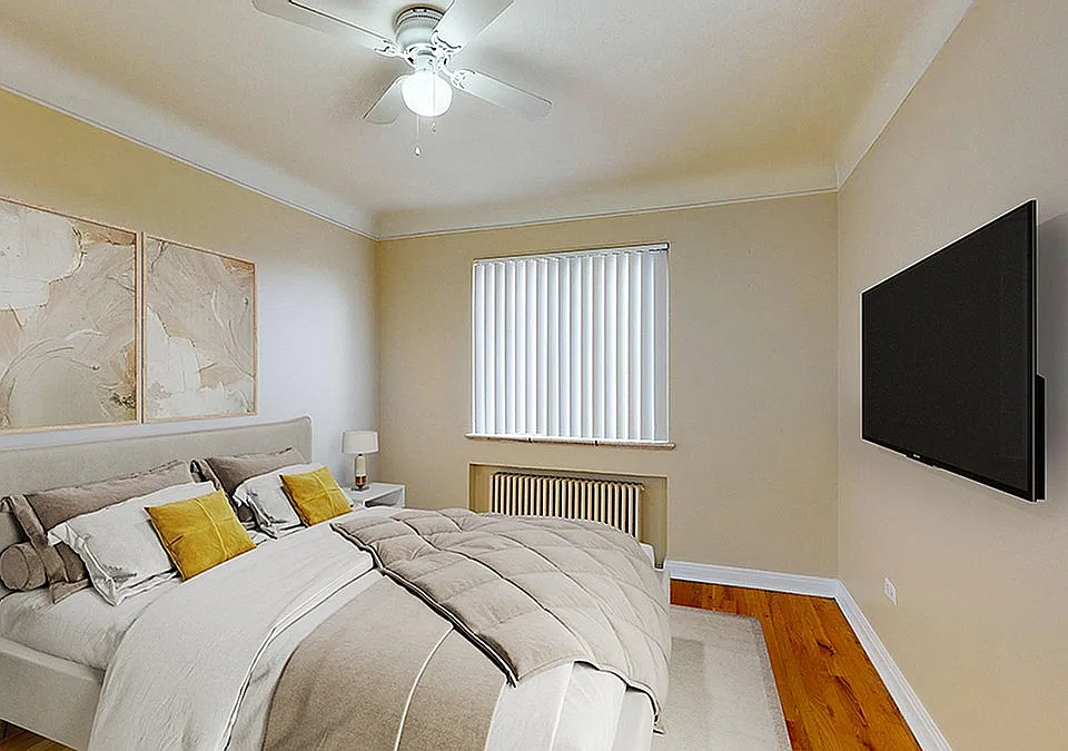 Elegant bedroom featuring a cozy bed with plush pillows, stylish wall art, a ceiling fan, and a mounted flat-screen TV for a modern lifestyle.