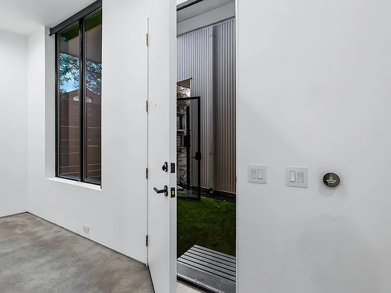 White interior wall with a smart thermostat control panel