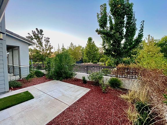 Front of home looks out onto open space and walking trail