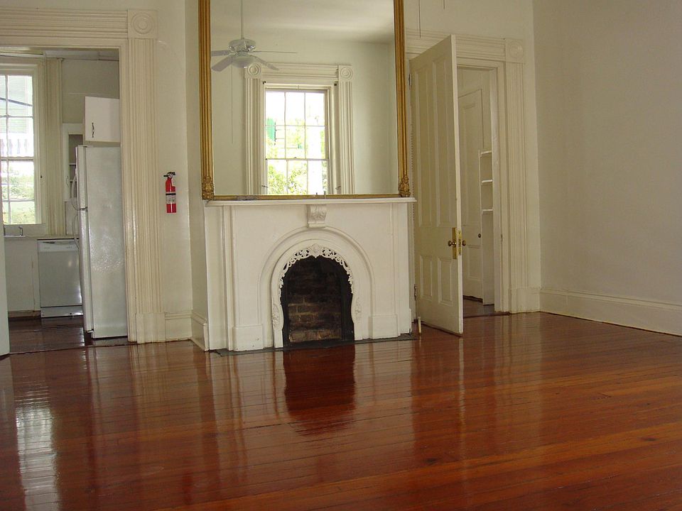 Living Room towards the rear with kitchen at left and bedroom to right