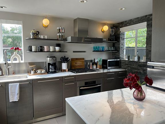 Fully stocked kitchen with Miele appliances, sub-zero fridge, built in steamer oven, microwave, gas stove, dishwasher, coffee maker with grinder, blender, and all the makings for a home-cooked meal and entertaining!