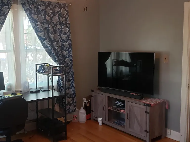 First bedroom + half bath with window looking towards street