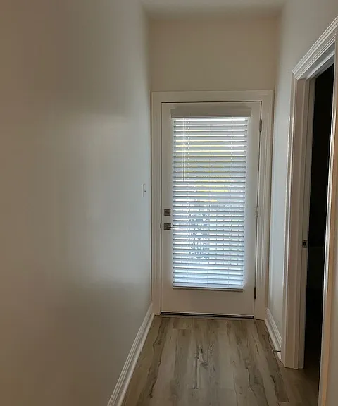 Front door. Downstirs Entrance Upstairs it leads to a balcony.