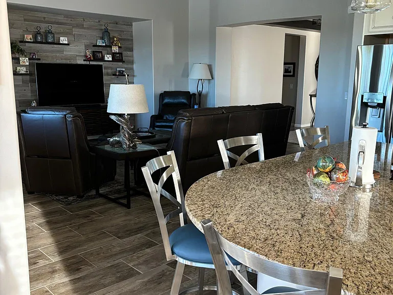 Family room from kitchen. Large, flat screen tv.