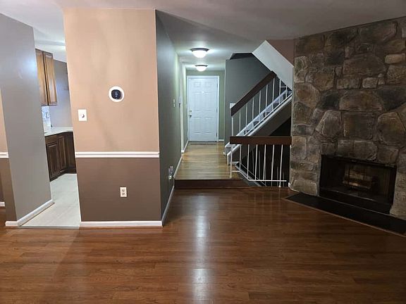 The welcoming main foyer offers a graceful entry point to the home, with immediate access to upper and lower levels.