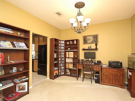 The formal dining room is currently setup as a home office and library.
