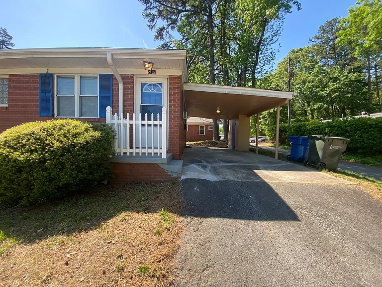 Private carport, in-unit laundry, and the Lakewood strip right outside your door. — Photo 2