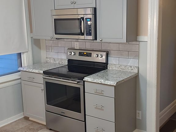 New Kitchen Cabs with Electric Range and Built in Microwave.