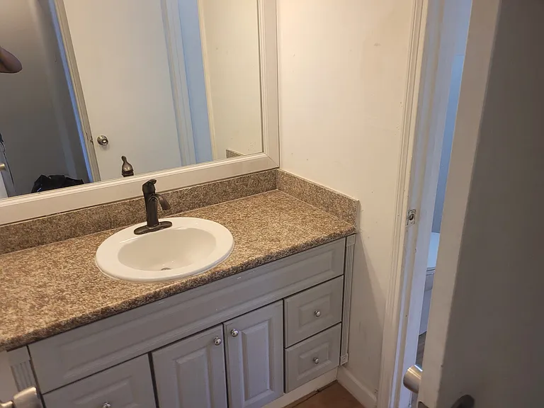 Upstairs water closet (sink) directly across from the stairs, connects to shower/toilet room (right door)