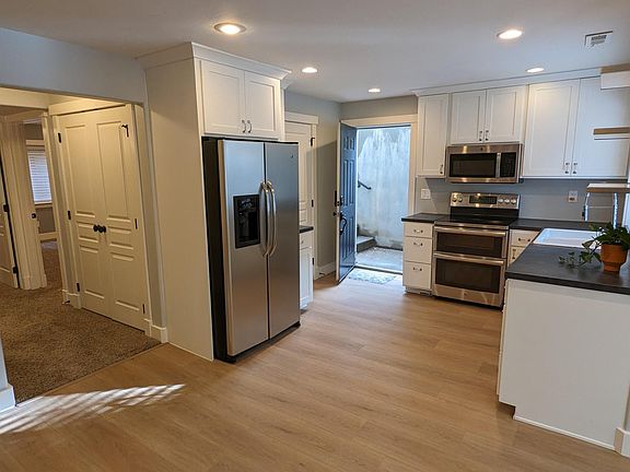 Access apartment by stairs through the open door. Enter in to the kitchen.