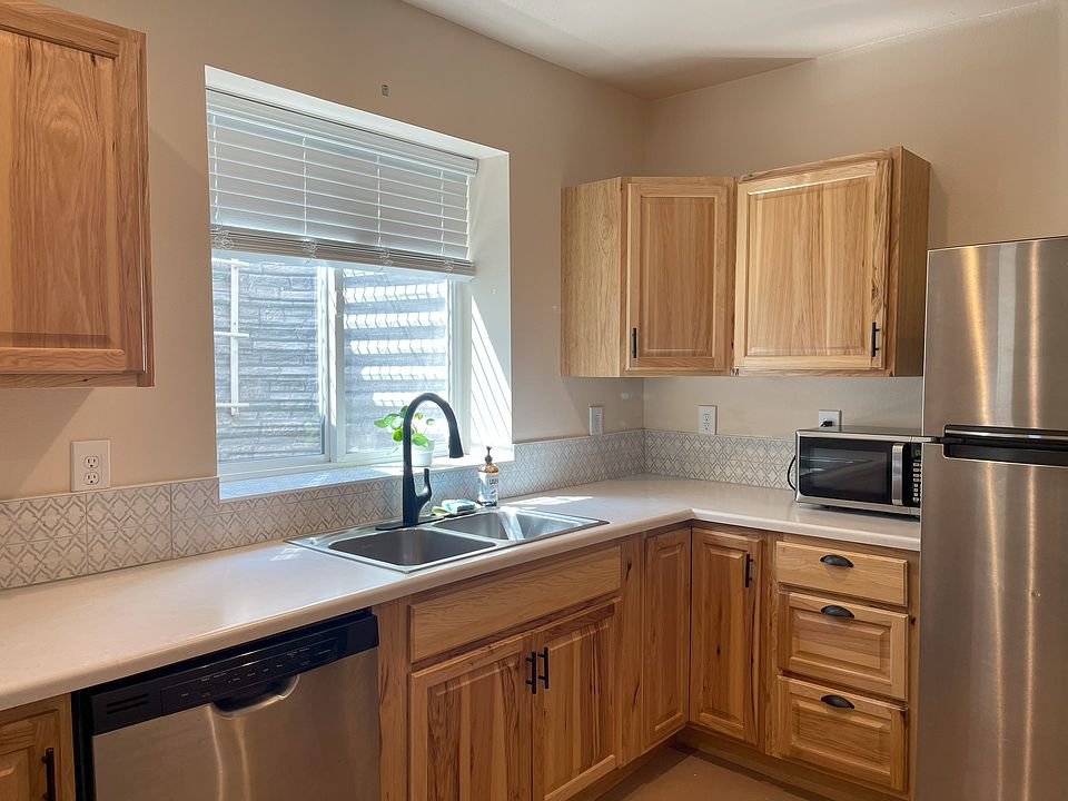 Kitchen with fridge, dishwasher and microwave.