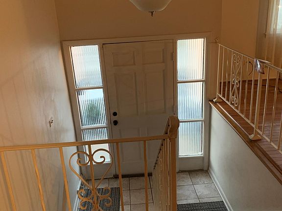 Entry door Ceramic an hardwood stairs case