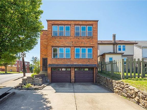Rear enclosed patio and garage. Driveway is shared with unit 2.
