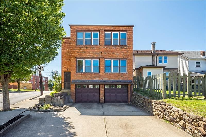Rear enclosed patio and garage. Driveway is shared with unit 2.