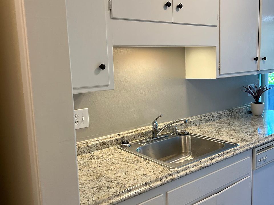 kitchen with newly painted white cabinets and oil rubbed bronze knobs