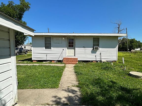 it is a duplex apartment building this apartment is in the back with a small storage space and a big backyard. This picture is your front yard.