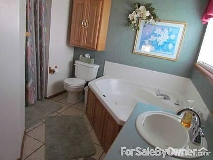 Master bath : Has dual sinks, jacuzzi tub, and walk-in shower. Extra above-stool cabinet.