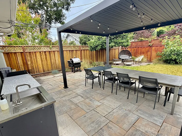 Outdoor sink, storage and pergola with adjustable shading and string lights