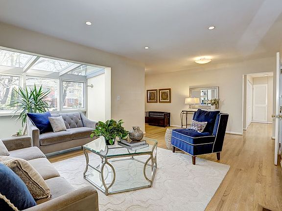 Illuminated Living Room w/ Adjacent Sunroom