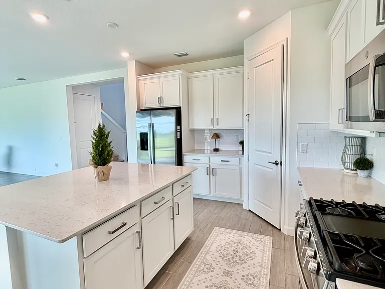 CHEF INSPIRED KITCHEN WITH LARGE ISLAND AND WALK IN CLOSET PANTRY