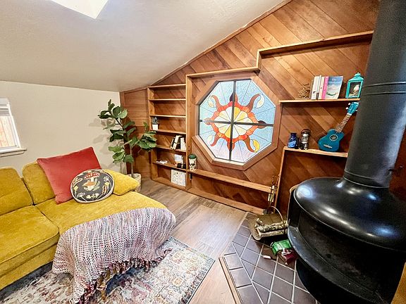 Custom redwood wall feature and shelving give this space a warm retro vibe and storage space