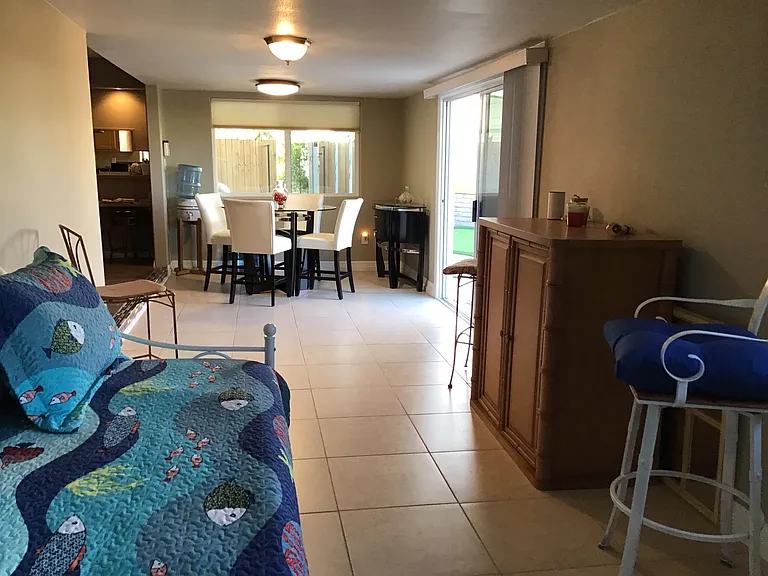 Tiled Patio room with twin trundle bed/ casual dining area overlooking backyard & pool