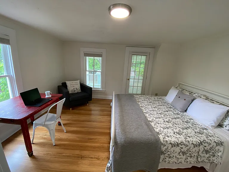 Upstairs west bedroom with space for remote work with table and chair.