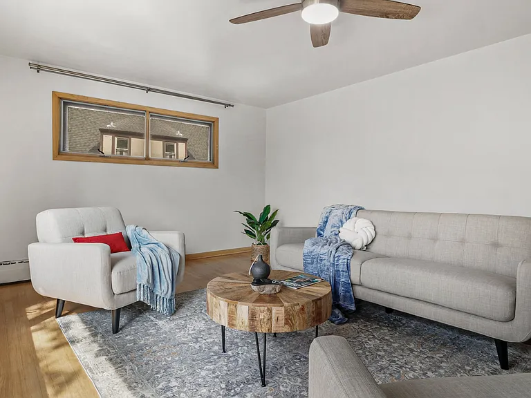 Nice large ceiling fan and lovely blonde hardwoods.