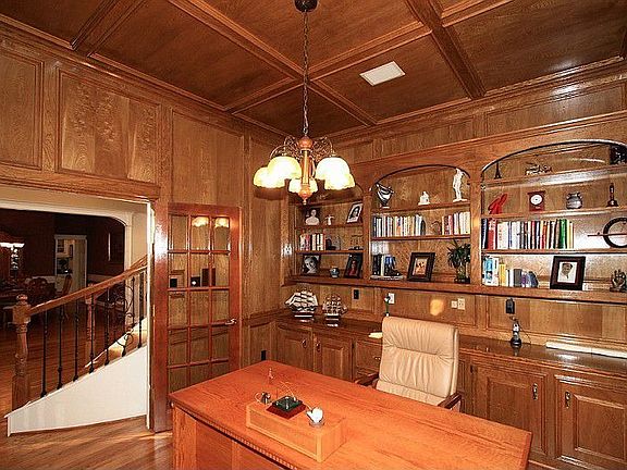Masculine Study featuring gorgeous wood work, built in bookcase, hrdwd floors