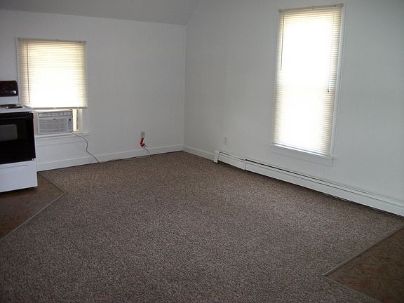 living room open to kitchen. Back door entrance off living room and small deck landing for grilling area.