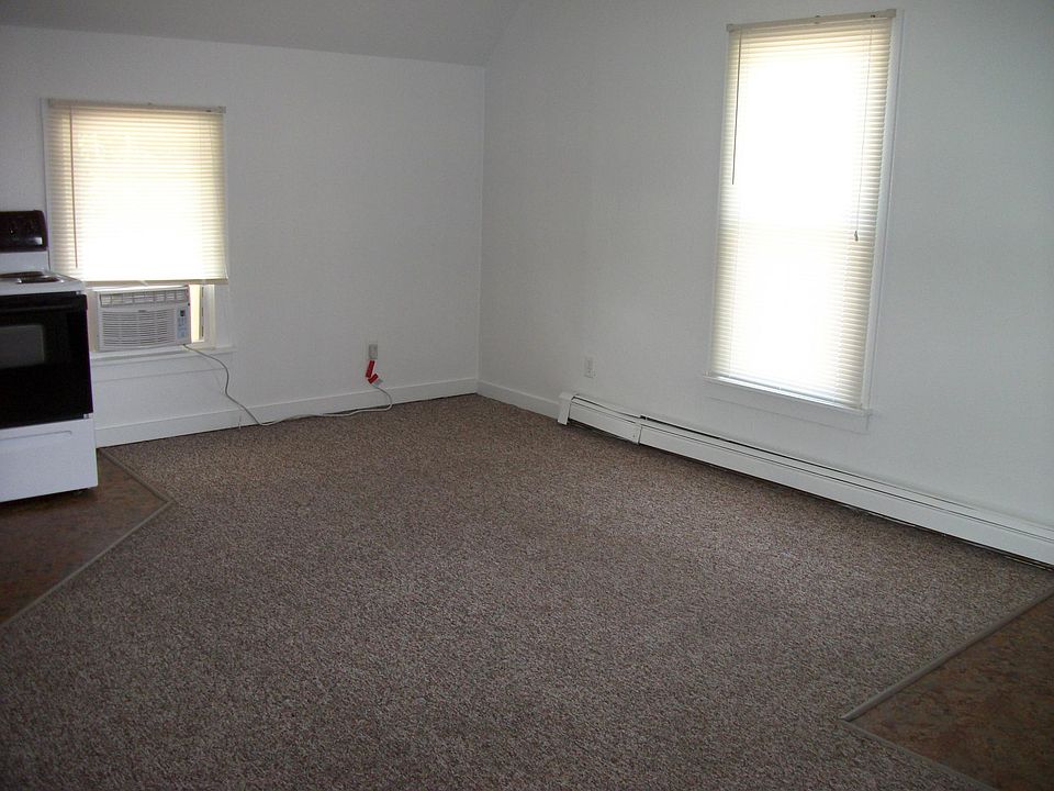 living room open to kitchen. Back door entrance off living room and small deck landing for grilling area.