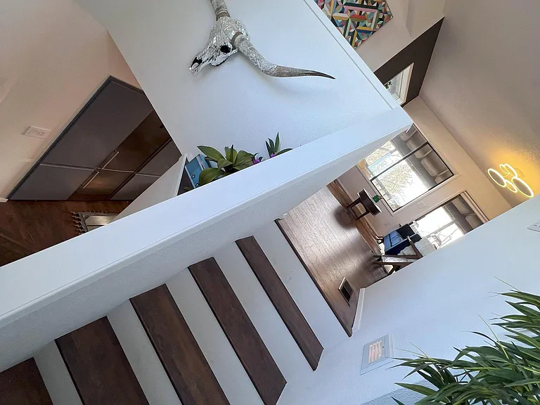 Stairway to the loft floor, also featuring new flooring throughout