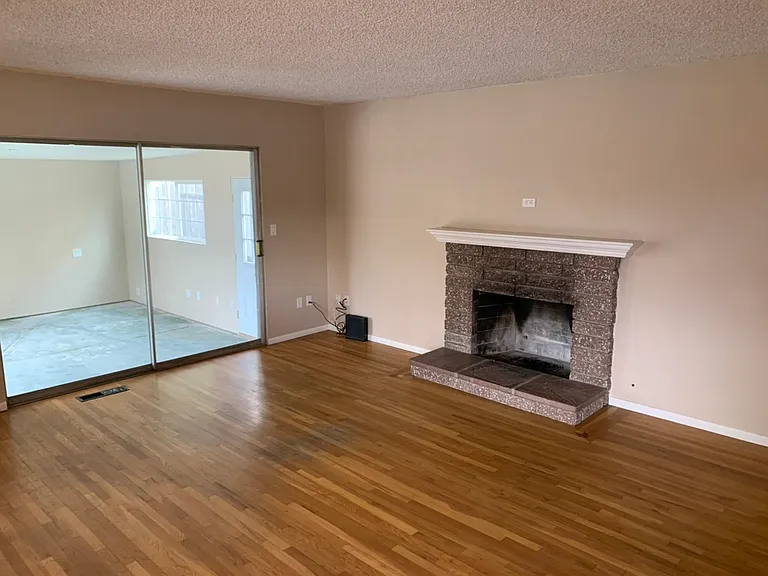 Living room with wood-burning fireplace.