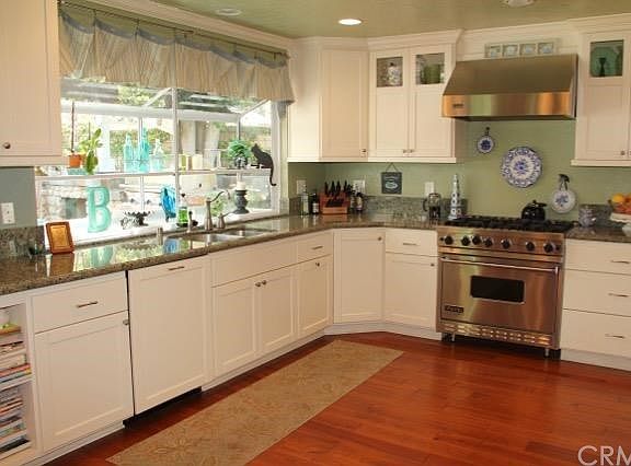 Granite counters, Viking range garden window and huge pantry cupboard in the updated kitchen.