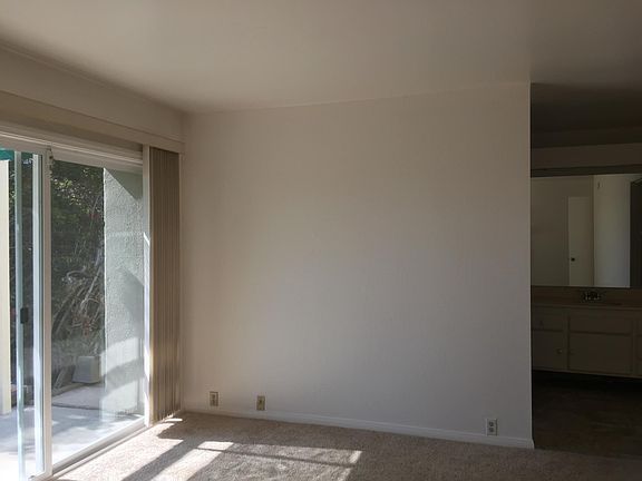 Master bedroom with sliding glass door to private west side. On right side is the master bath and walk in closet