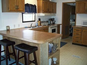 Large kitchen with lots of cabinets and counter-tops.