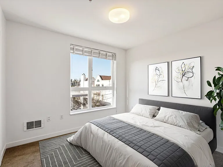 Spacious and bright bedroom at 4400 Alaska in Seattle, WA. Enjoy natural light from the large window, plush queen-size bed, and ample closet space in this mo...