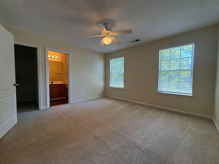 2nd master bedroom with view of en suite bathroom and walk in closet.