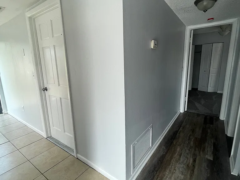 downstairs hallway to common bath/ 4th bed & door to garage