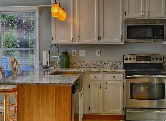 White cabinets, new granite and stainless appliances complete this great kitchen.