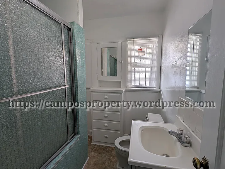 Bathroom with built in cabinetry. New toilet installed.