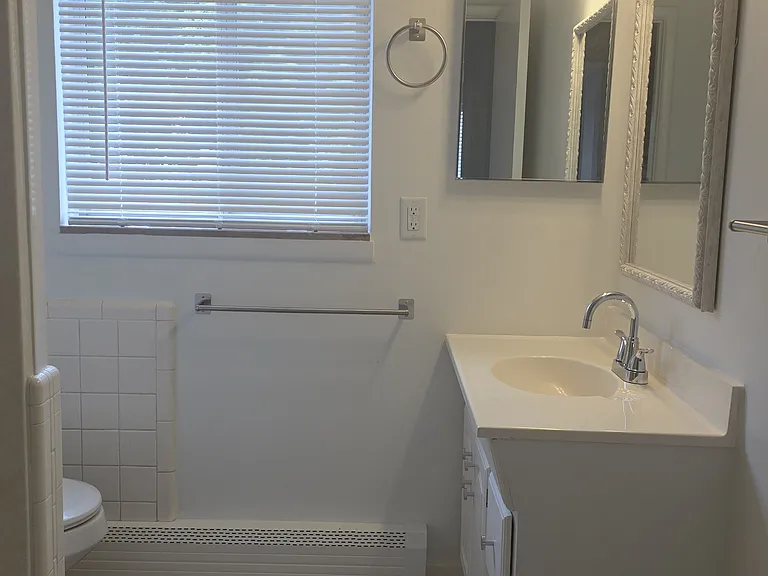 Bright second-level full bathroom with vanity, natural light, and tub/shower.