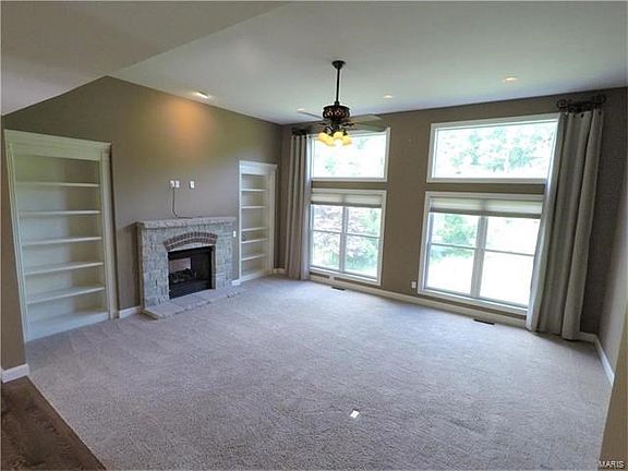 Great Room with a Gorgeous Wooded View ~ Built-in Shelving ~ Two-way Gas Fireplace '