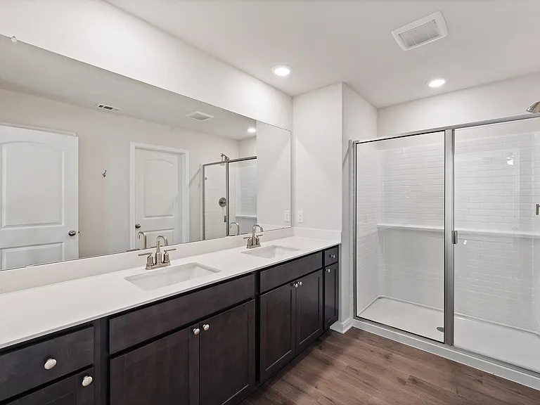 The master bathroom has a sprawling dual-sink vanity.