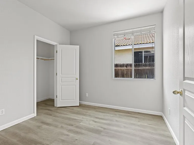 Bedroom #2 with recessed lightning, window blinds, and closet