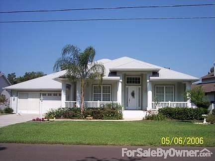 Beautiful Florida Waterfront Home : A wrap around porch adds charm and the wide stairway says welcom