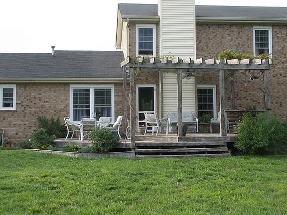 Rear of house, sits on 1 acre lot in family-friendly neighborhood